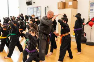 Photo of students and instructor using combinations in Karate class
