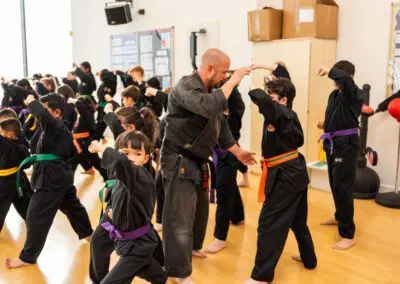 Photo of students and instructor using combinations in Karate class