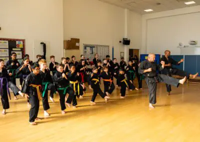 Photo of students and instructor using combinations in Karate class