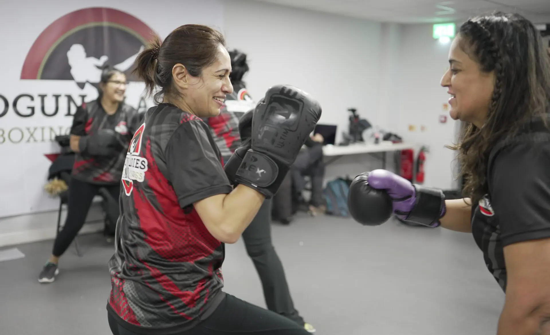 Image of 2 women sparring in a kickboxing class