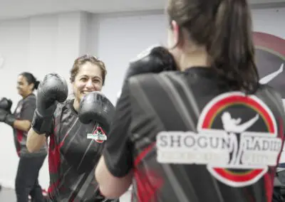 Image of 2 women sparring in a kickboxing class