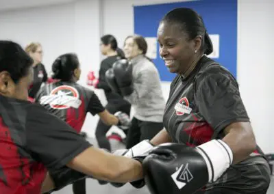 Image of 2 women sparring in a kickboxing class