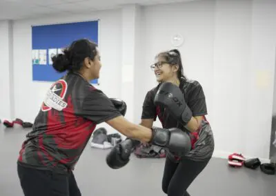 Image of 2 women sparring in a kickboxing class